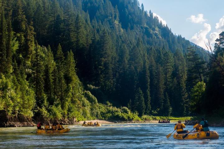 a small boat in a body of water with a mountain in the background