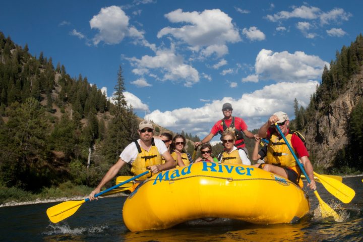 a man riding on the back of a boat in the water