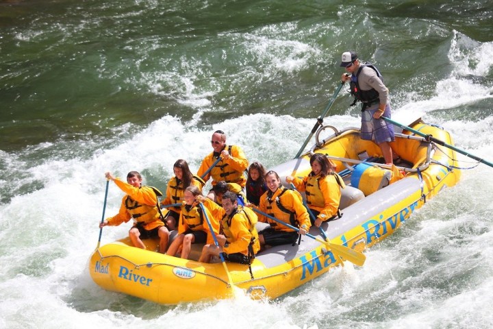 a man riding on a raft in a body of water