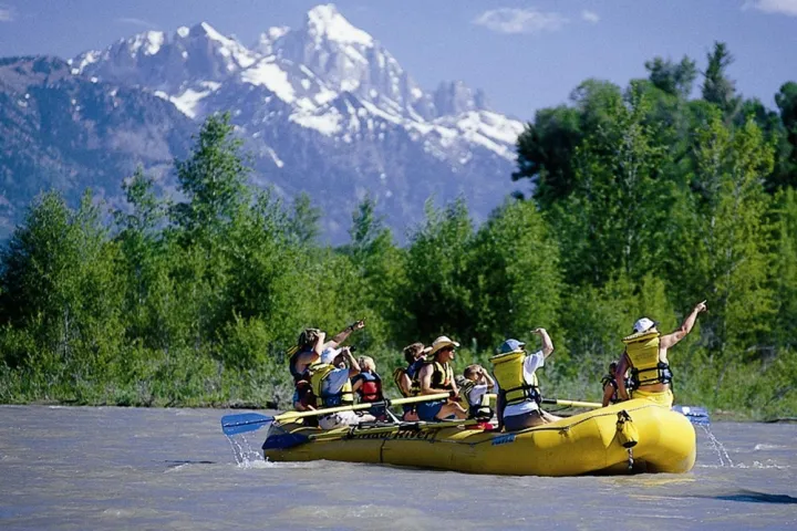 a group of people riding on the back of a boat