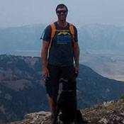 a man standing in front of a mountain