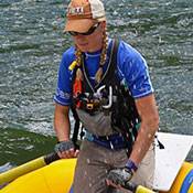a man standing next to a body of water