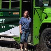 a person standing next to a bus